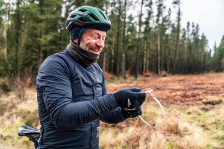 A rider in a forest setting in winter gear