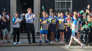 Young cycling volunteer carries Queen&rsquo;s Baton at 10 Downing Street